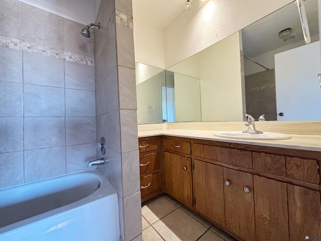 bathroom with vanity, tiled shower / bath combo, and tile patterned floors