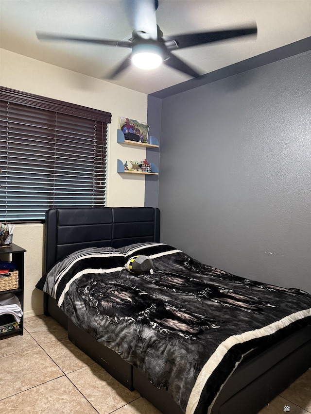 tiled bedroom featuring a ceiling fan