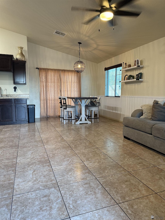 dining space featuring a ceiling fan, visible vents, and light tile patterned floors