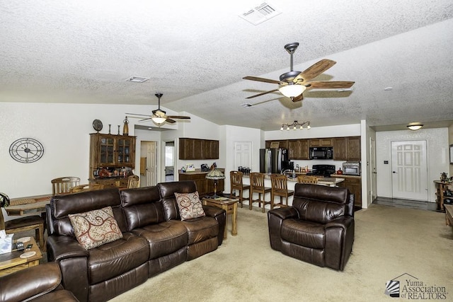 carpeted living room with a textured ceiling, ceiling fan, and lofted ceiling