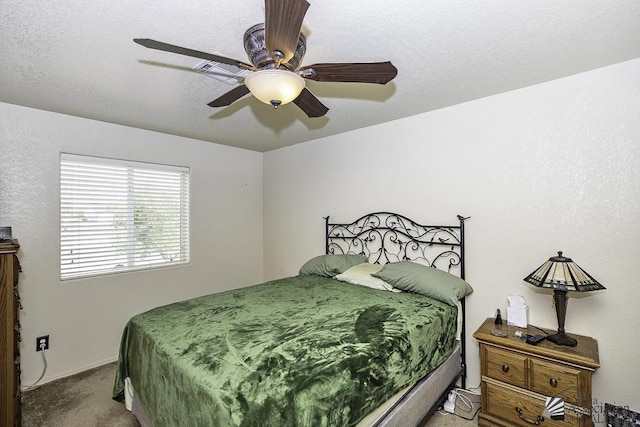 carpeted bedroom featuring a textured ceiling and ceiling fan