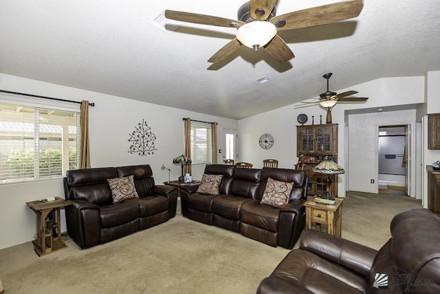 living room featuring carpet flooring, plenty of natural light, and lofted ceiling