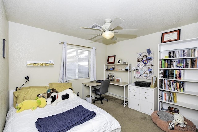 bedroom featuring carpet flooring, ceiling fan, and a textured ceiling