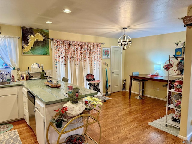 kitchen featuring tile counters, white cabinets, and light hardwood / wood-style floors