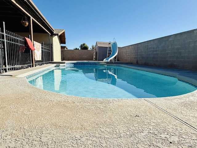 view of pool with a water slide