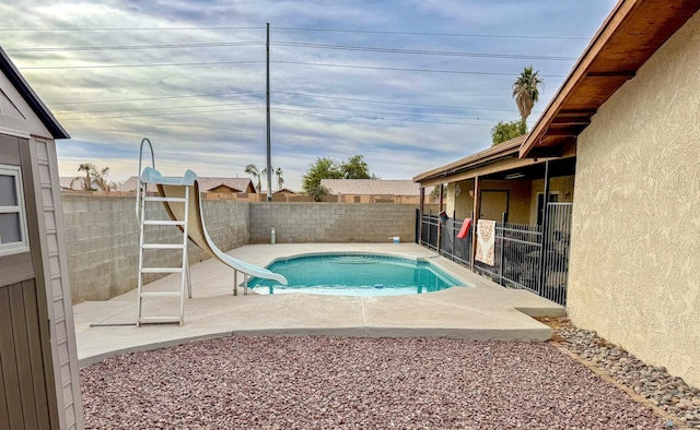 view of pool with a patio and a water slide