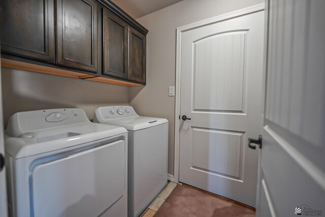 laundry area featuring washer and dryer and cabinets