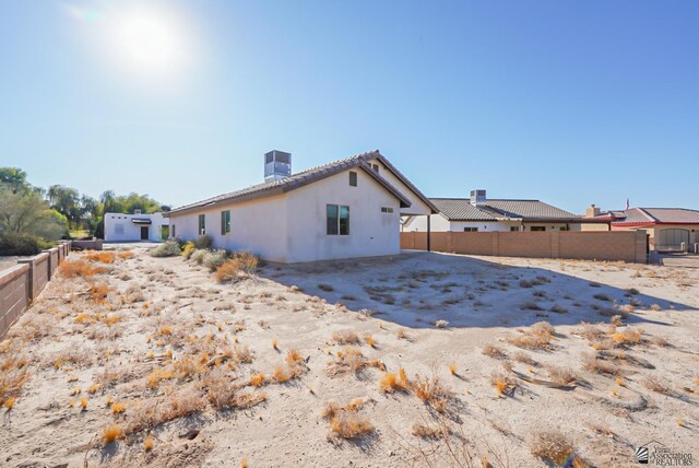 rear view of house with central AC unit