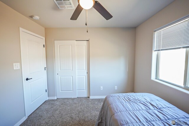 unfurnished bedroom featuring ceiling fan and carpet floors