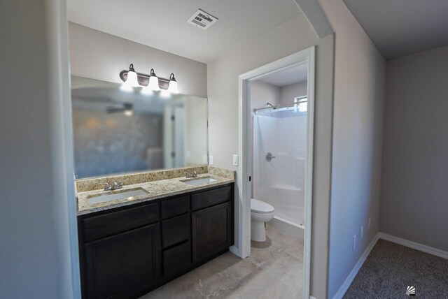 bathroom with toilet, a shower, and vanity