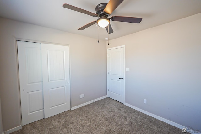 unfurnished bedroom featuring ceiling fan, a closet, and light carpet