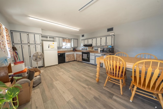 kitchen with gray cabinetry, extractor fan, sink, black appliances, and light hardwood / wood-style flooring