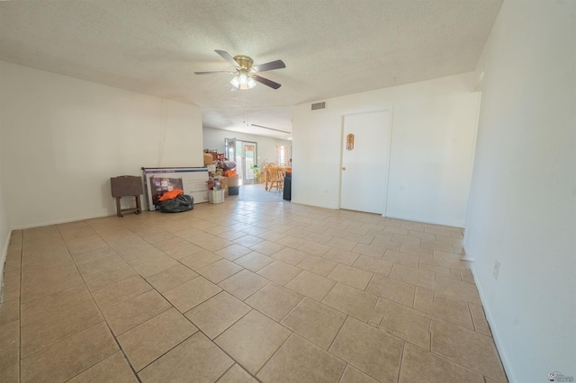 tiled empty room with a textured ceiling and ceiling fan