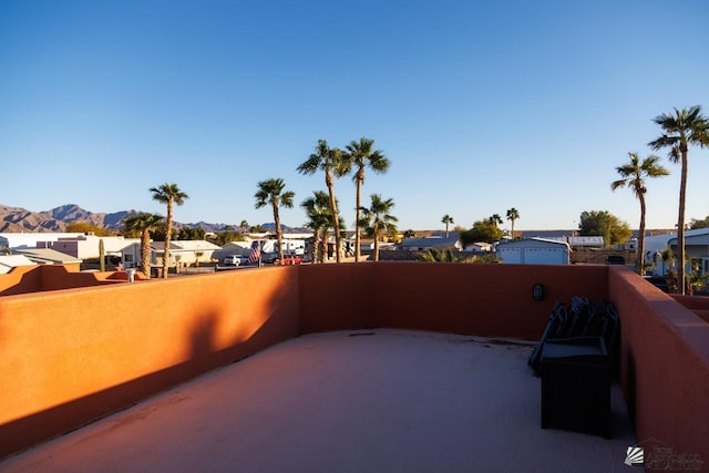 view of patio / terrace with a residential view, a mountain view, and a balcony