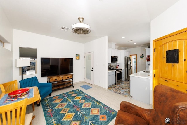 living area featuring recessed lighting and visible vents