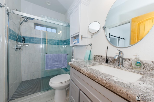 full bath featuring a stall shower, vanity, and toilet