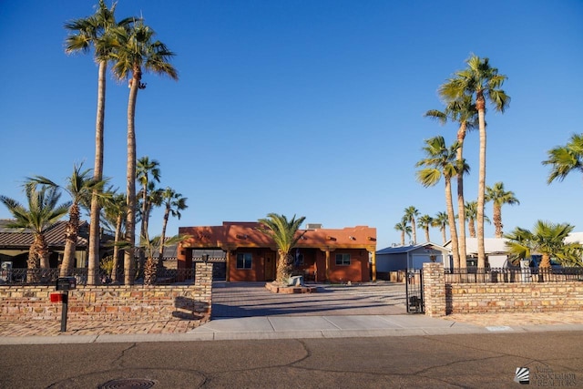 pueblo-style house with a fenced front yard