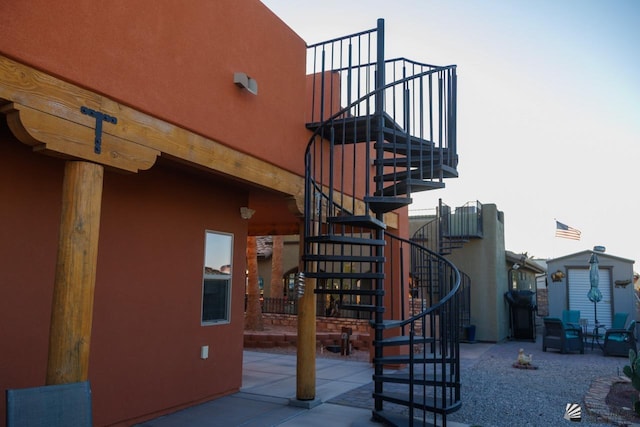 exterior space with stairway and a patio area