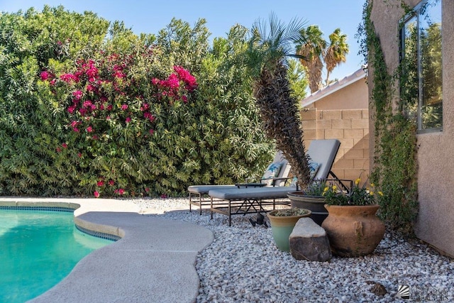 pool featuring a patio area and fence