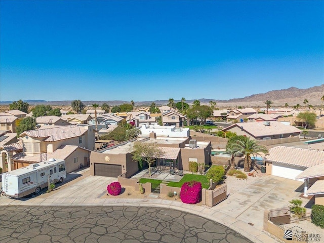 drone / aerial view featuring a residential view and a mountain view