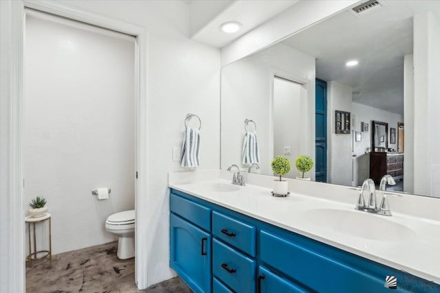 full bath featuring toilet, double vanity, a sink, and visible vents