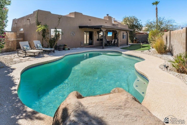 view of swimming pool featuring a patio area, a fenced backyard, and a fenced in pool