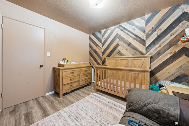 bedroom featuring a textured ceiling and light wood-style floors