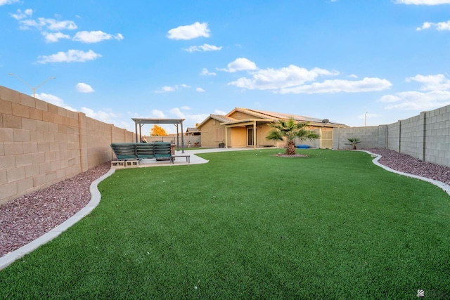 view of yard featuring a fenced backyard, a patio, and an outdoor hangout area