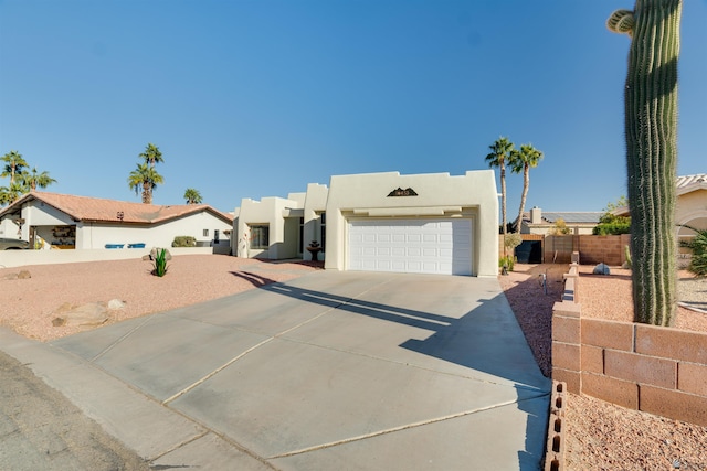 pueblo-style home with a garage