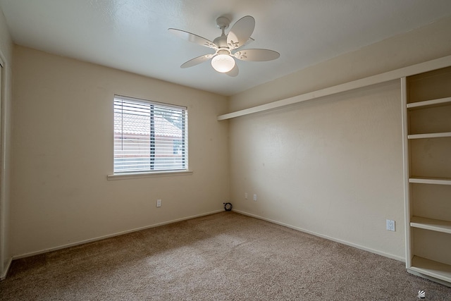 unfurnished room featuring ceiling fan and carpet flooring