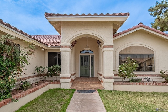 entrance to property featuring a lawn