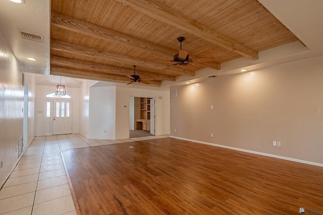 unfurnished room with wood ceiling, ceiling fan, light hardwood / wood-style flooring, and beamed ceiling