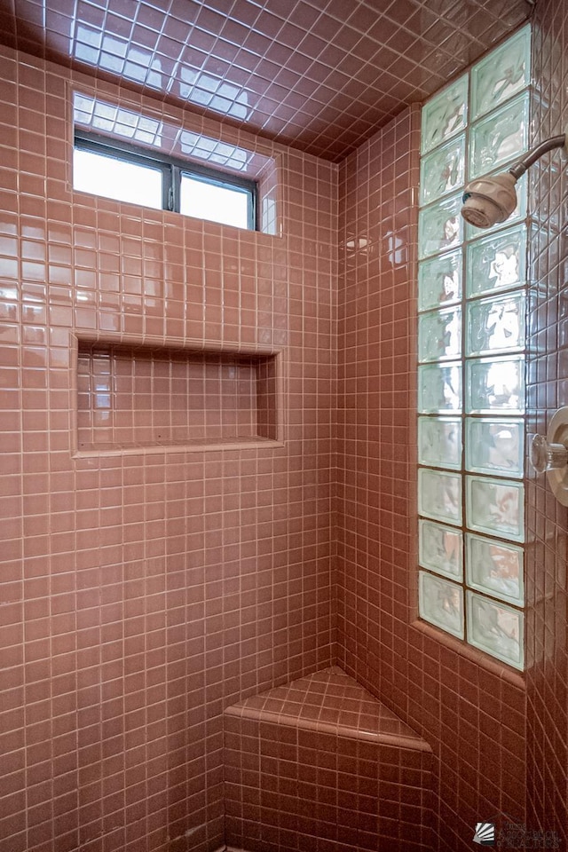 bathroom with tiled shower