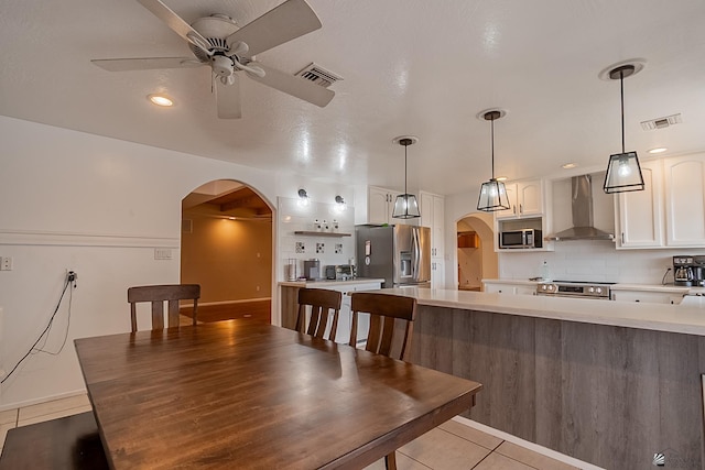 dining space with light tile patterned floors and ceiling fan