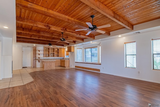 unfurnished living room featuring ceiling fan, wood ceiling, light hardwood / wood-style floors, and beamed ceiling