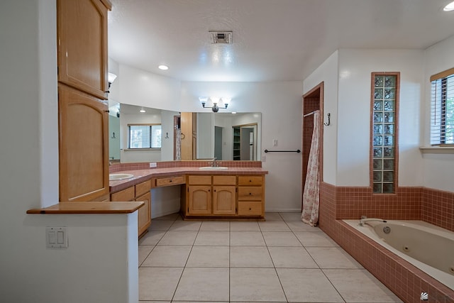 bathroom with vanity, tile patterned floors, and shower with separate bathtub