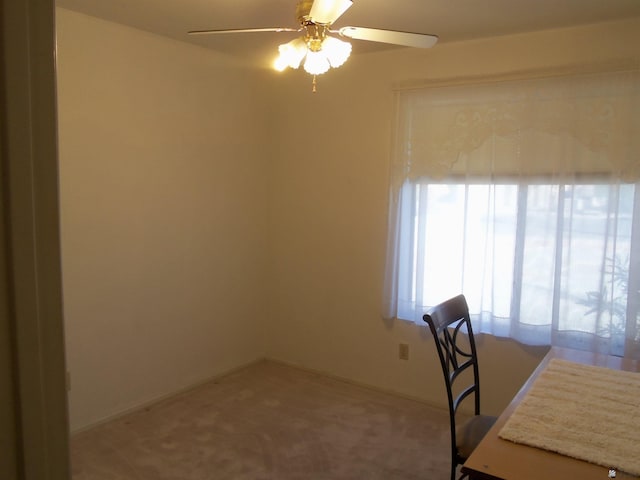 unfurnished office with carpet floors and a ceiling fan