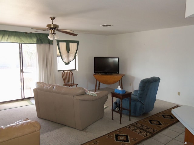 living room featuring visible vents and a ceiling fan