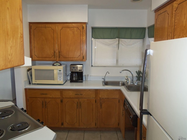 kitchen with brown cabinetry, white appliances, a sink, and light tile patterned floors