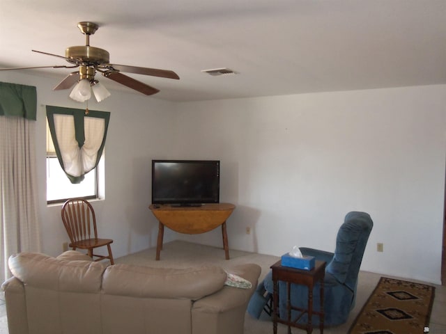 living room featuring ceiling fan and visible vents