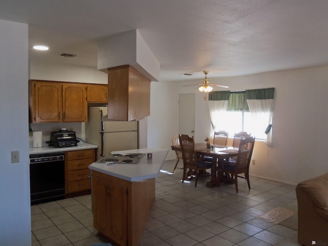 kitchen featuring a ceiling fan, light countertops, freestanding refrigerator, dishwasher, and brown cabinetry