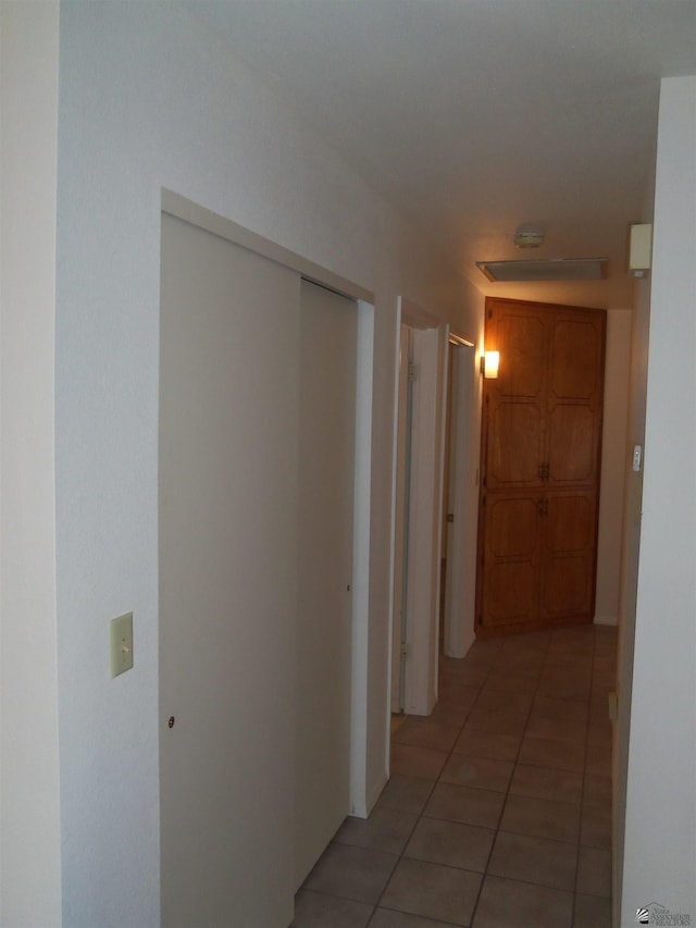 hallway featuring light tile patterned floors