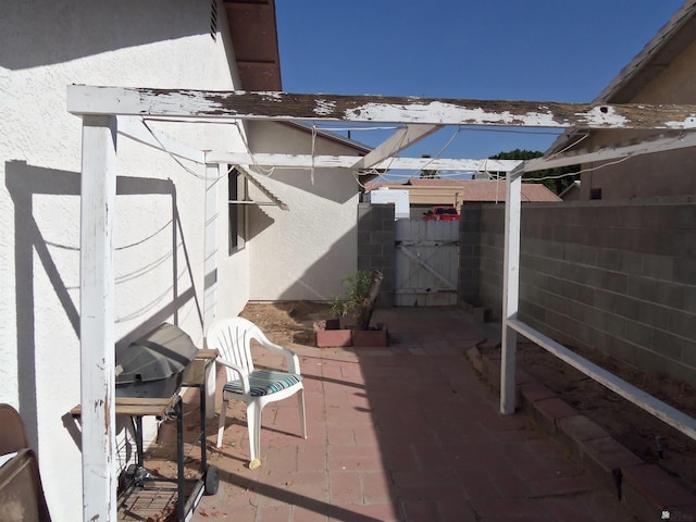 view of patio / terrace featuring a gate and fence