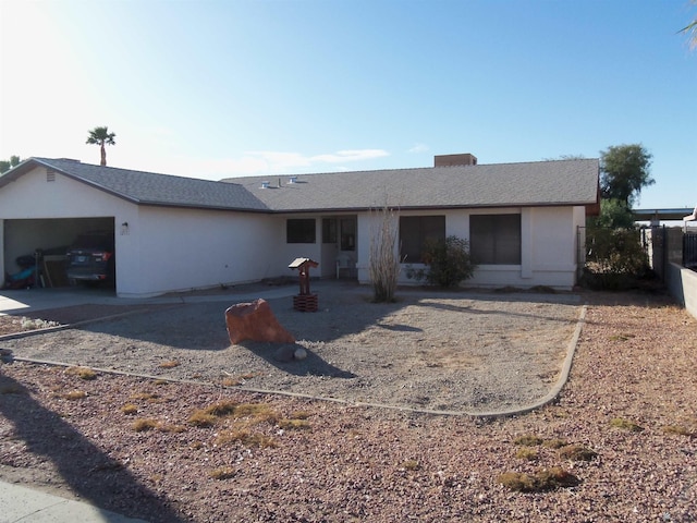 single story home featuring a patio and an attached garage