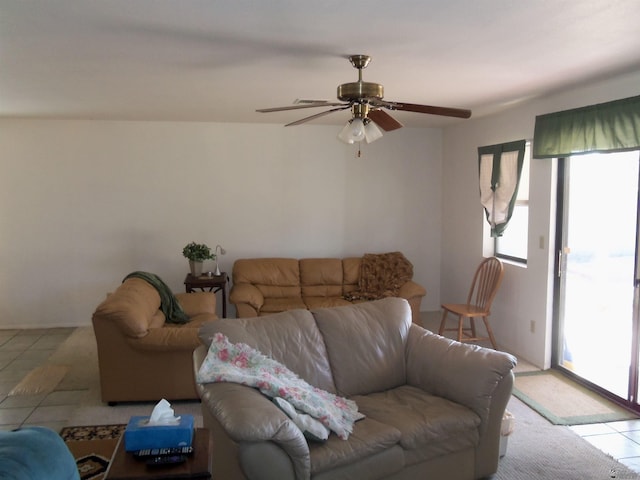 living room featuring light tile patterned floors and ceiling fan