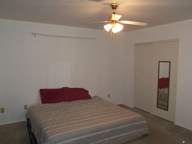 bedroom featuring ceiling fan, a closet, visible vents, and carpet flooring