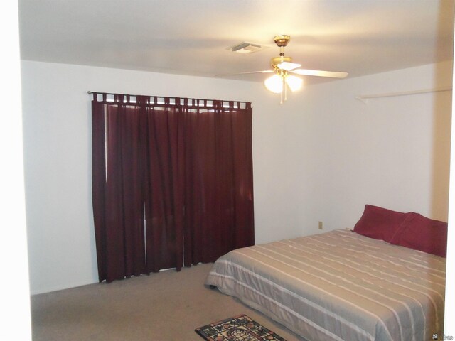 carpeted bedroom with ceiling fan and visible vents