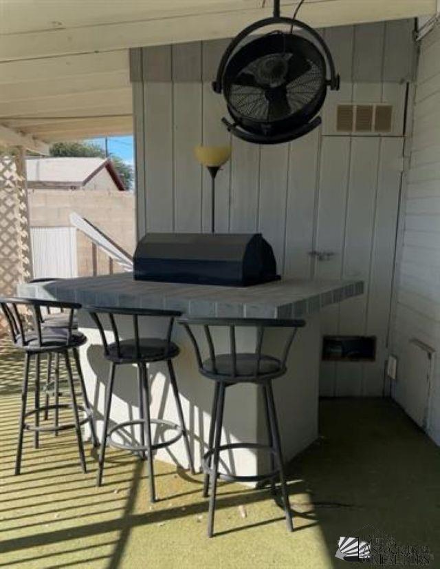 interior space with a breakfast bar area and visible vents