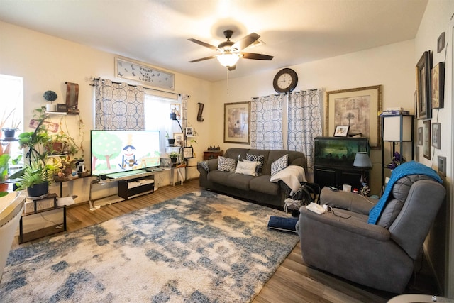 living room featuring hardwood / wood-style floors and ceiling fan