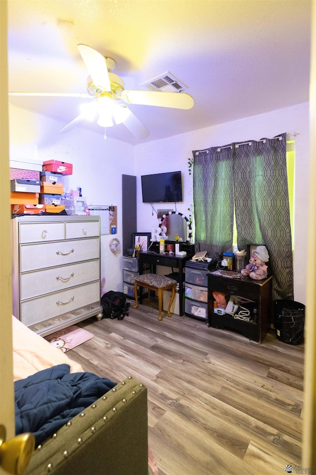 bedroom with wood-type flooring and ceiling fan